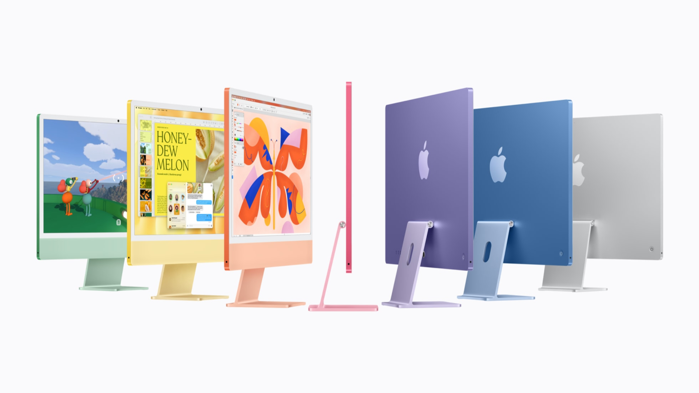 Seven 24-inch iMacs in a row in green, yellow, orange, pink, purple, blue, and silver, some facing front and some turned away